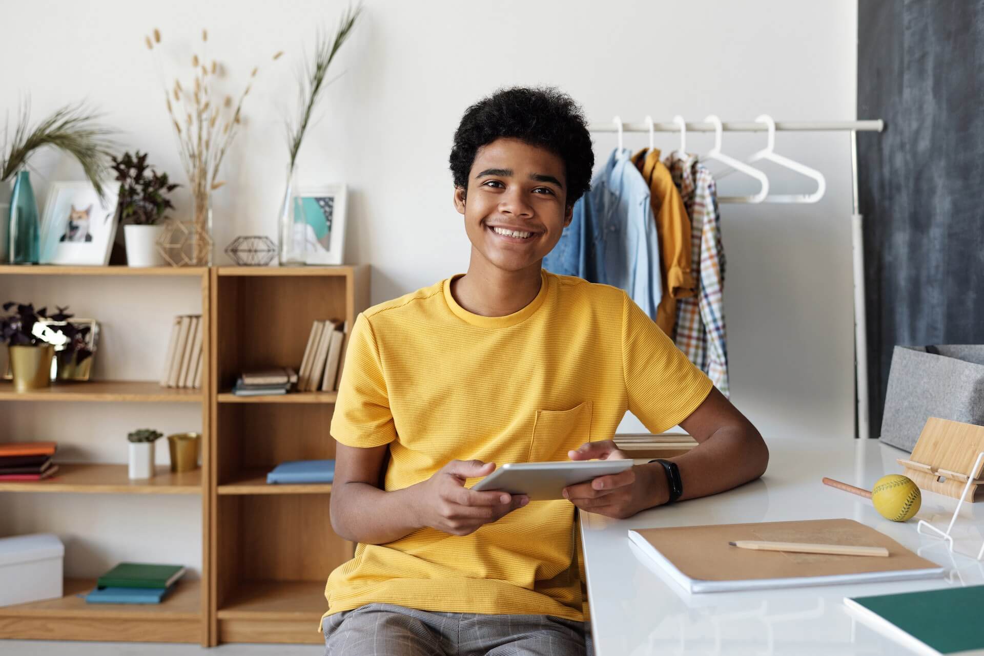Kid smiling holding iPad