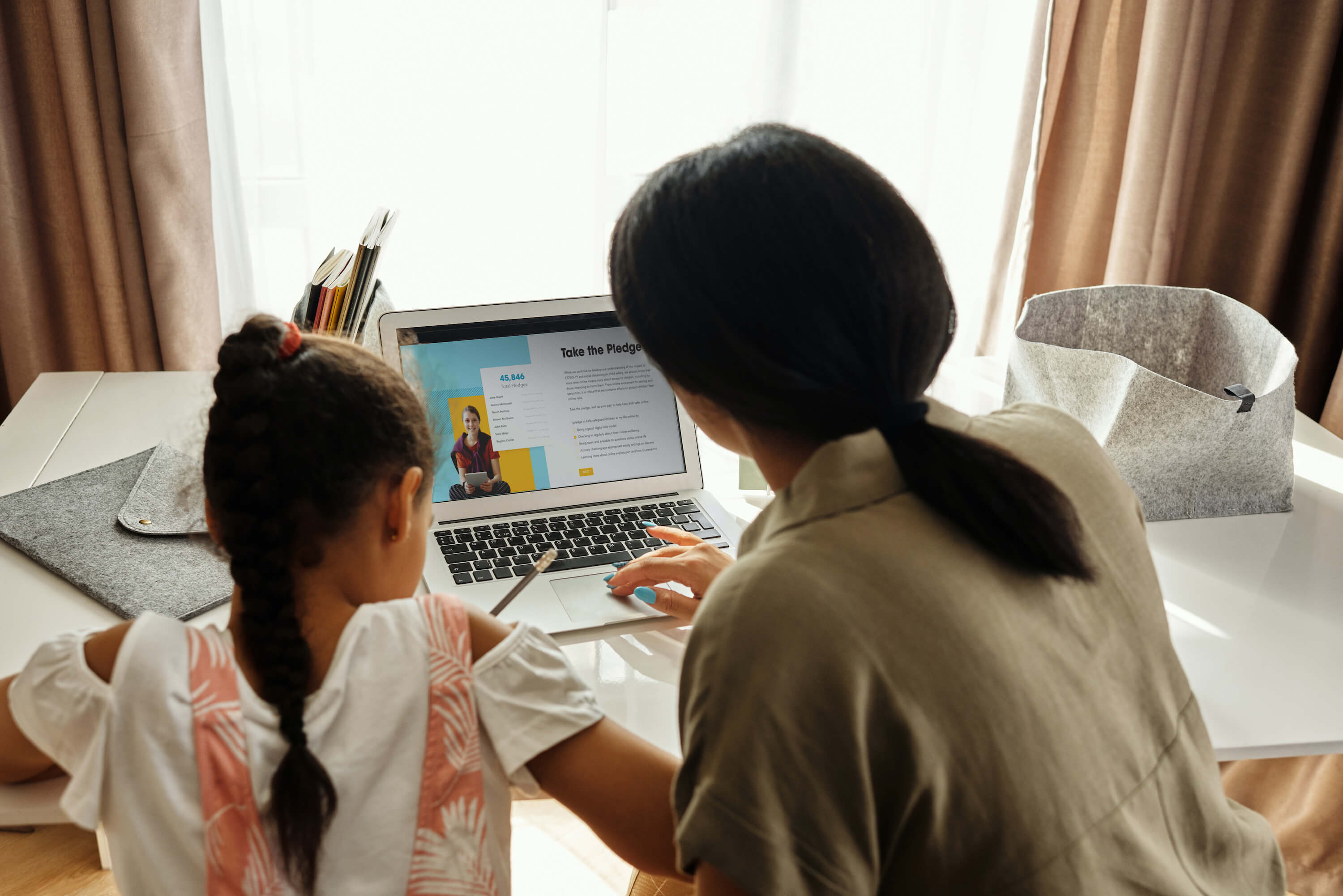 Mother and child filling out Safety Pledge